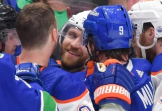 Edmonton Oilers superstar forward Leon Draisaitl in the middle of a scrum with Vancouver Canucks players