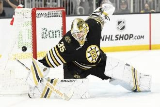 Boston Bruins goaltender Linus Ullmark making a save during a home game in the NHL.
