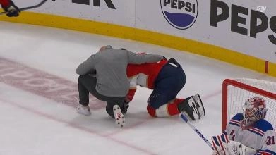 Evan Rodrigues is checked by a trainer after an elbow from Jacob Trouba