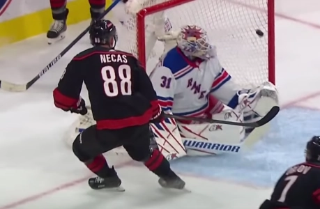 Carolina Hurricanes forward Martin Necas scoring a goal in the playoffs against New York Rangers goaltender Igor Shesterkin