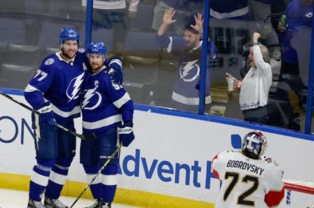 Victor Hedman and Steven Stamkos with the Tampa Bay Lightning celebrating a goal against the Florida Panthers.