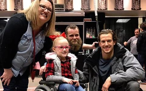 Danny DeKeyser meeting with a fan and family