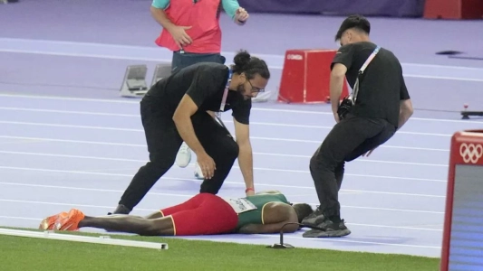 Runner Lamecha Girma trips and collapses during Olympic event