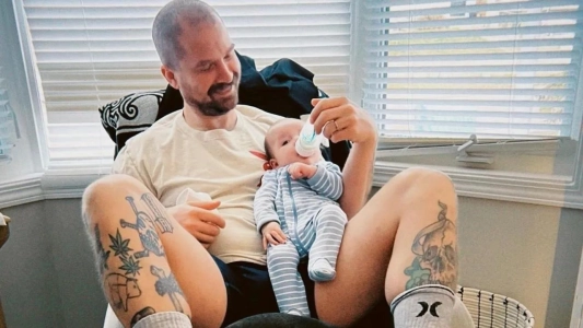 Kyle Brodziak's brother Ryan seen feeding his baby Ozzy