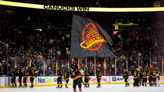 Vancouver Canucks players celebrate a win on the ice