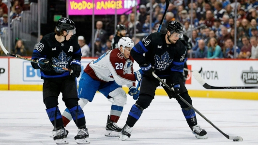 Nathan MacKinnon of the Colorado Avalanche with Mitch Marner and Auston Matthews of the Toronto Maple Leafs