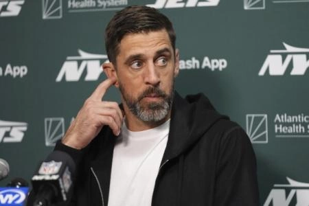 Aaron Rodgers, quarterback of the New York Jets, speaks to the media