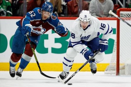 Mar 8, 2025; Denver, Colorado, USA; Toronto Maple Leafs right wing Mitch Marner (16) controls the puck ahead of Colorado Avalanche left wing Artturi Lehkonen (62) in the first period at Ball Arena. Mandatory Credit: Isaiah J. Downing-Imagn Images