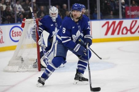 Jan 5, 2025; Toronto, Ontario, CAN; Toronto Maple Leafs defenceman Chris Tanev (8) helps defend the net against the Philadelphia Flyers during the second period at Scotiabank Arena. Mandatory Credit: John E. Sokolowski-Imagn Images
