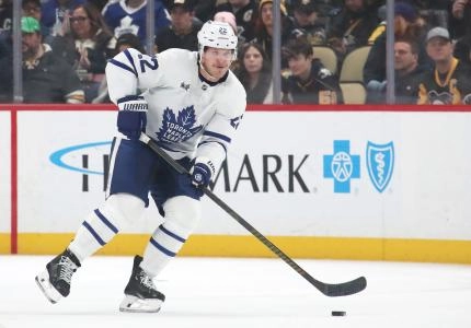 Mar 2, 2025; Pittsburgh, Pennsylvania, USA; Toronto Maple Leafs defenseman Jake McCabe (22) moves the puck against the Pittsburgh Penguins during the second period at PPG Paints Arena. Mandatory Credit: Charles LeClaire-Imagn Images