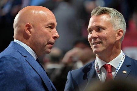 Jul 7, 2022; Montreal, Quebec, CANADA; Montreal Canadiens general manager Kent Hughes (left) talks with head coach Martin St. Louis before the first round of the 2022 NHL Draft at Bell Centre. Mandatory Credit: Eric Bolte-Imagn Images