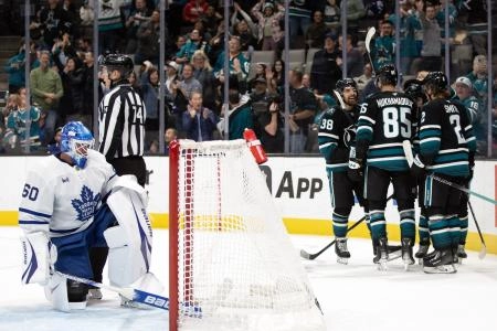 Mar 27, 2025; San Jose, California, USA; San Jose Sharks players celebrate a goal against Toronto Maple Leafs goaltender Joseph Woll (60) during the second period at SAP Center at San Jose. Mandatory Credit: D. Ross Cameron-Imagn Images