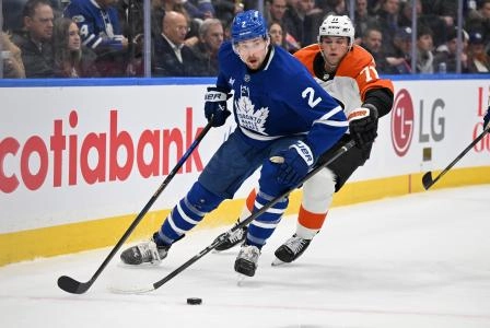 Mar 25, 2025; Toronto, Ontario, CAN; Toronto Maple Leafs defenseman Simon Benoit (2) moves the puck away from Philadelphia Flyers forward Tyson Foerster (71) in the second period at Scotiabank Arena. Mandatory Credit: Dan Hamilton-Imagn Images