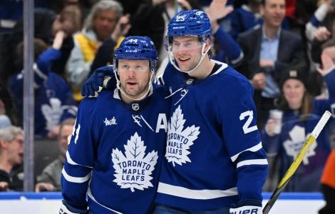 Mar 25, 2025; Toronto, Ontario, CAN; Toronto Maple Leafs defenseman Brandon Carlo (25) greets defenseman Morgan Rielly (44) after a goal that was eventually disallowed in the third period against the Philadelphia Flyers at Scotiabank Arena. Mandatory Credit: Dan Hamilton-Imagn Images