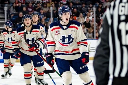 Noah Chadwick celebrates scoring a goal with his teammates on the bench during a Lethbridge Hurricanes game; Chadwick captained the Hurricanes in the 2024-25 season. Photo Credit: WHL Images