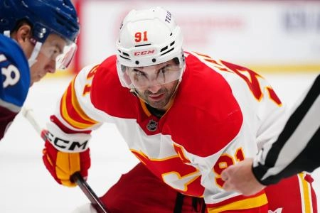 Mar 31, 2025; Denver, Colorado, USA; Calgary Flames center Nazem Kadri (91) prepares to take a face-off in the first period against the Colorado Avalanche at Ball Arena. Mandatory Credit: Ron Chenoy-Imagn Images