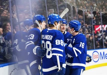 Jan 20, 2025; Toronto, Ontario, CAN; Toronto Maple Leafs left wing Matthew Knies (23) scores a goal and celebrates with right wing William Nylander (88) against the Tampa Bay Lightning during the third period at Scotiabank Arena. Mandatory Credit: Nick Turchiaro-Imagn Images