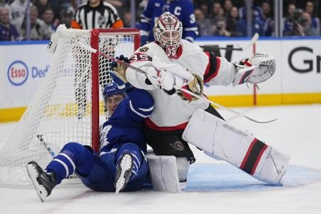 Apr 20, 2025; Toronto, Ontario, CAN; Ottawa Senators goaltender Linus Ullmark (35) pins Toronto Maple Leafs forward Matthew Knies (23) against the goalpost during the third period of game one of the first round of the 2025 Stanley Cup Playoffs at Scotiabank Arena. Mandatory Credit: John E. Sokolowski-Imagn Images