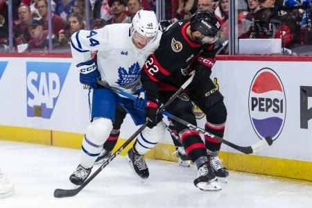 Apr 24, 2025; Ottawa, Ontario, CAN; Toronto Maple Leafs defenseman Morgan Rielly (44) battles with Ottawa Senators right wing Michael Amadio (22) for control of the puck in game three of the first round of the 2025 Stanley Cup Playoffs at Canadian Tire Centre. Mandatory Credit: Marc DesRosiers-Imagn Images