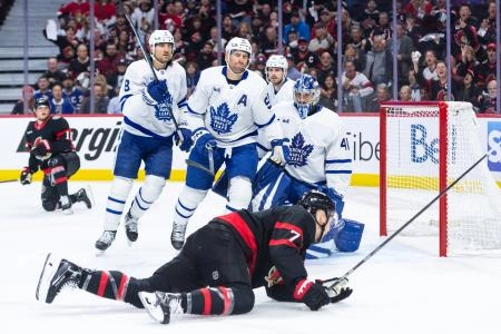 Apr 24, 2025; Ottawa, Ontario, CAN; Ottawa Senators left wing Brady Tkachuk (7) is tripped by Toronto Maple Leafs center John Tavares (91) in a play in front of goalie Anthony Stolarz (41) in game three of the first round of the 2025 Stanley Cup Playoffs at Canadian Tire Centre. Mandatory Credit: Marc DesRosiers-Imagn Images