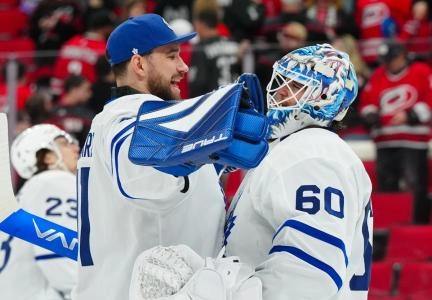 Apr 13, 2025; Raleigh, North Carolina, USA; Toronto Maple Leafs goaltender Joseph Woll (60) and goaltender Anthony Stolarz (41) celebrate their victory against the Carolina Hurricanes at Lenovo Center. Mandatory Credit: James Guillory-Imagn Images