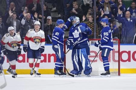 Apr 2, 2025; Toronto, Ontario, CAN; Toronto Maple Leafs forward John Tavares (91) and defenseman Oliver Ekman-Larsson (95) congratulate goaltender Anthony Stolarz (41) after a win against the Florida Panthers at Scotiabank Arena. Mandatory Credit: John E. Sokolowski-Imagn Images
