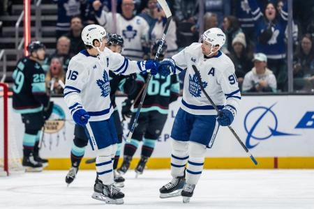 Feb 6, 2025; Seattle, Washington, USA; Toronto Maple Leafs forward Mitch Marner (16) and forward John Tavares (91) celebrate a goald during the first period against the Seattle Kraken at Climate Pledge Arena. Mandatory Credit: Stephen Brashear-Imagn Images