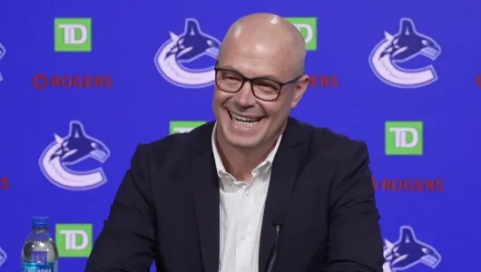 Vancouver Canucks GM Patrik Allvin smiles as he speaks to reporters