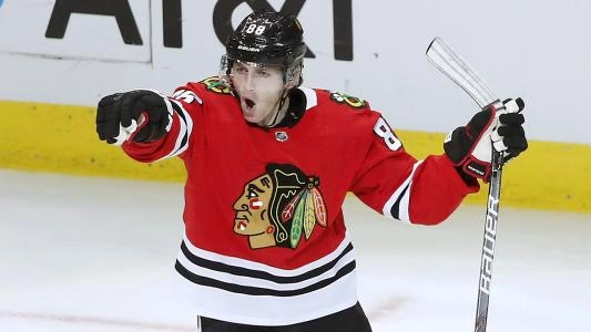 Chicago Blackhawks' Patrick Kane celebrates a goal by pointing to a teammate