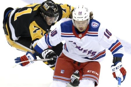 Penguins forward Evgeni Malkin chases New York's Artemi Panarin