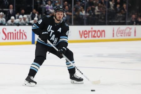 Apr 8, 2025; Salt Lake City, Utah, USA; Utah Hockey Club defenseman Mikhail Sergachev (98) plays the puck during a second period power play against the Seattle Kraken at Delta Center. Mandatory Credit: Rob Gray-Imagn Images
