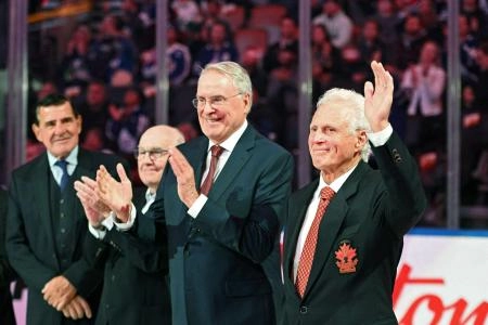 Sep 28, 2022; Toronto, Ontario, CAN; Former NHL and Team Canada player Paul Henderson waves as he is applauded by team mates (from right) Ken Dryden, Ron Ellis and Serge Savard during a ceremony to honor members of the team that played in the 1972 Summit Series against the Soviet Union before the start of the Montreal Canadiens at Toronto Maple Leafs game at Scotiabank Arena