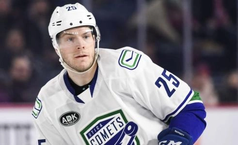 Former Vancouver Canucks defenseman Brogan Rafferty playing a game in the AHL with the Utica Comets.