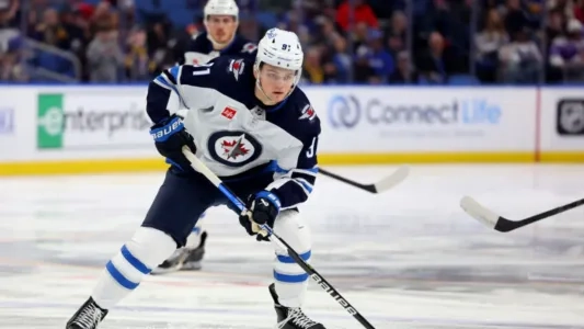 Winnipeg Jets forward Cole Perfetti playing in a road game in the NHL.