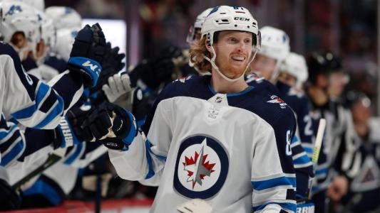 Winnipeg Jets forward Kyle Connor celebrating a goal during a road game in the NHL.