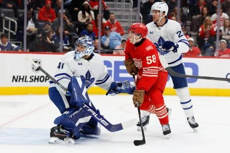 Oct 11, 2025; Detroit, Michigan, USA; Toronto Maple Leafs goaltender Anthony Stolarz (41) makes the save in front of Detroit Red Wings center Emmitt Finnie (58) in the second period at Little Caesars Arena. Mandatory Credit: Rick Osentoski-Imagn Images