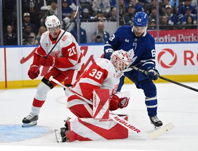 Oct 13, 2025; Toronto, Ontario, CAN; Detroit Red Wings goalie Cameron Talbot (39) makes a save in front of defenceman Albert Johansson (20) and Toronto Maple Leafs left wing Matias Maccelli (63) in the first period at Scotiabank Arena. Mandatory Credit: Gerry Angus-Imagn Images