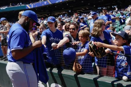 Jul 7, 2024; Seattle, Washington, USA; Toronto Blue Jays first baseman Vladimir Guerrero Jr. signs autographs for fans pregame at T-Mobile Park. Mandatory Credit: John Froschauer-Imagn Images