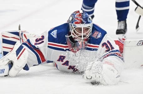 Oct 16, 2025; Toronto, Ontario, CAN; New York Rangers goalie Igor Shesterkin (31) reaches to cover the puck against the Toronto Maple Leafs in the first period at Scotiabank Arena.