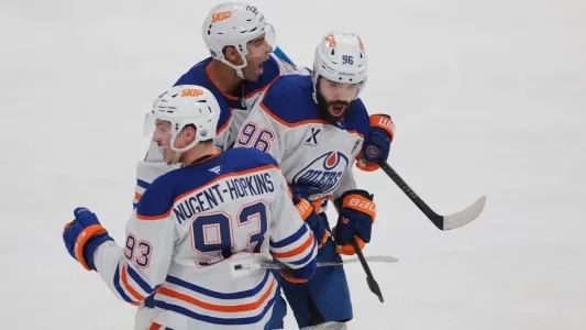 Edmonton Oilers players, including Jake Walman, celebrating a goal
