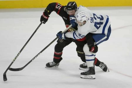 Sep 21st, 2025; Ottawa, Ontario, CAN; Ottawa Senators left wing Olle Lycksell (15) battles with Toronto Maple Leafs left wing Landon Sim (42) for control of the puck in the third period at the Canadian Tire Centre. Mandatory Credit: Marc DesRosiers-IMAGN Images