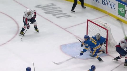 Blues goalie Jordan Binnington saving a shot taken by Alex Ovechkin.