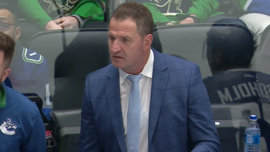 Vancouver Canucks head coach Adam Foote behind the bench