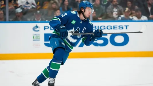 Vancouver Canucks' Quinn Hughes skates during a hockey game