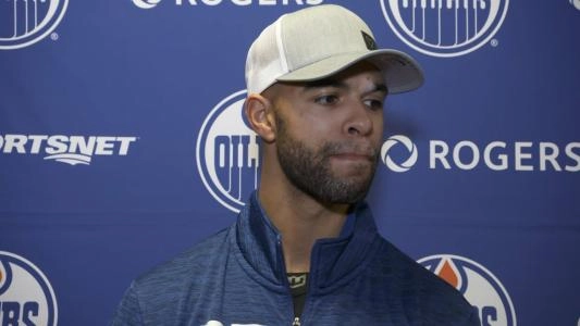Edmonton Oilers' Darnell Nurse listens to a reporter's question