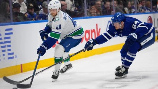 Toronto Maple Leafs' David Kampf battles for the puck vs. the Vancouver Canucks
