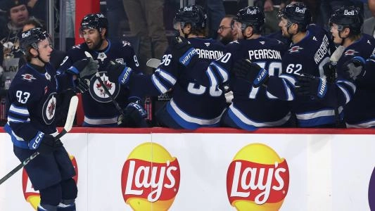 Winnipeg Jets' Brad Lambert celebrates a goal with his teammates on the bench