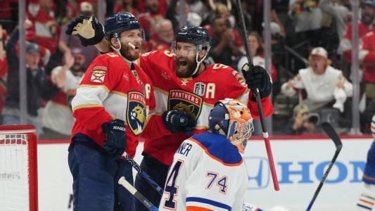 Florida Panthers players celebrate a goal in front of Edmonton Oilers' Stuart Skinner