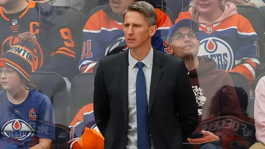 Edmonton Oilers head coach Kris Knoblauch stands behind the bench