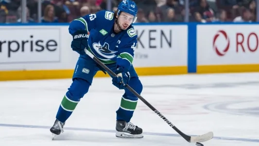 Vancouver Canucks' Quinn Hughes skates with the puck